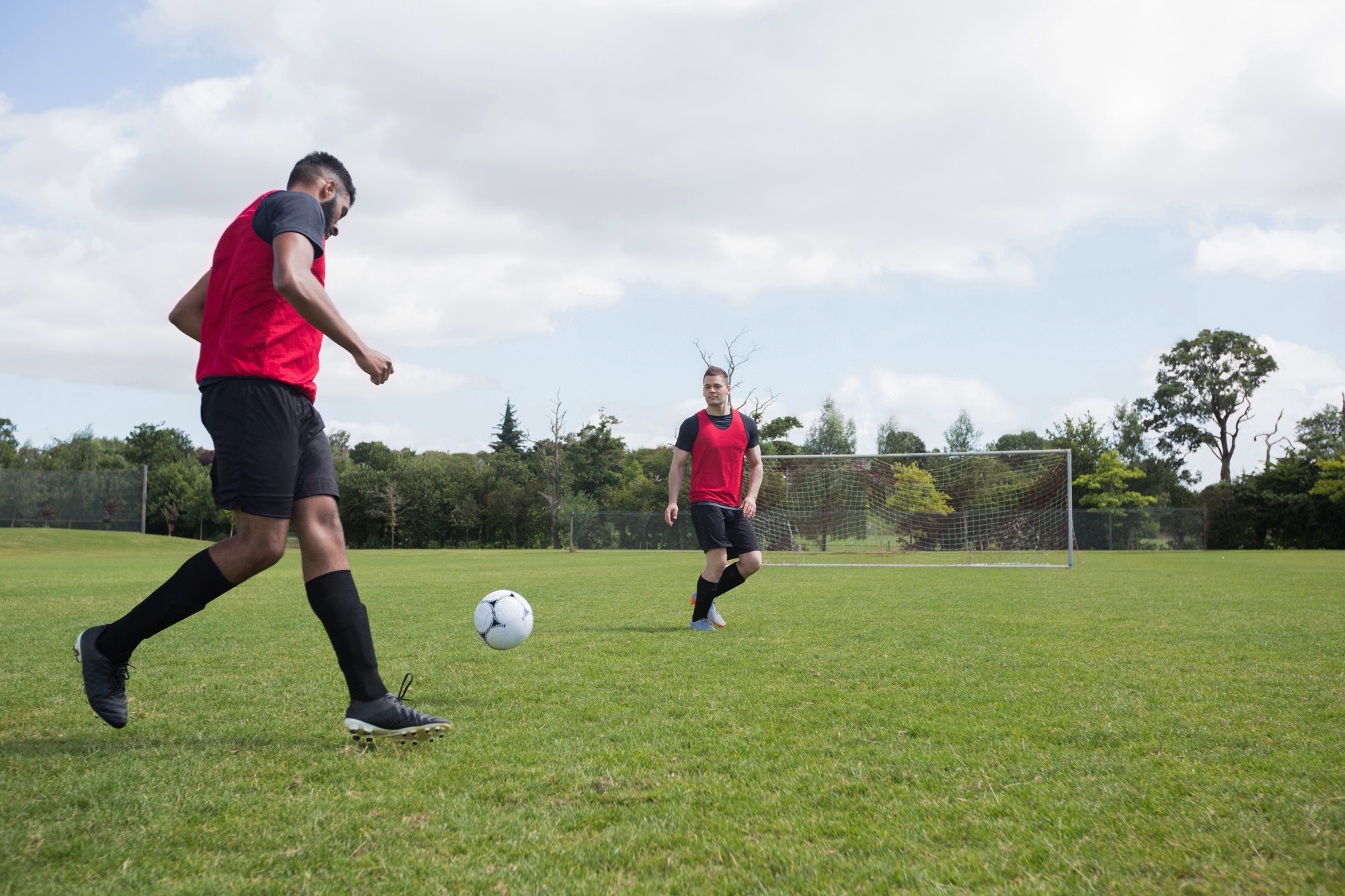 Football players playing soccer in the ground