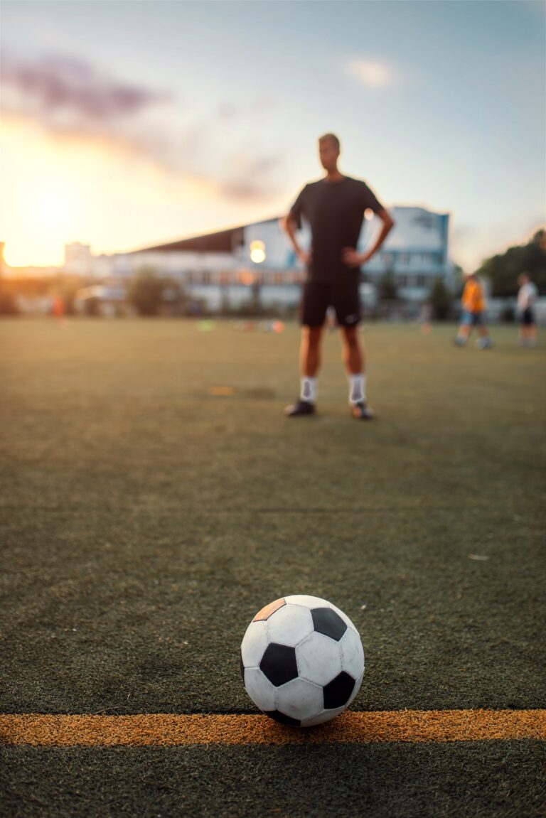 Soccer ball on line, player on background