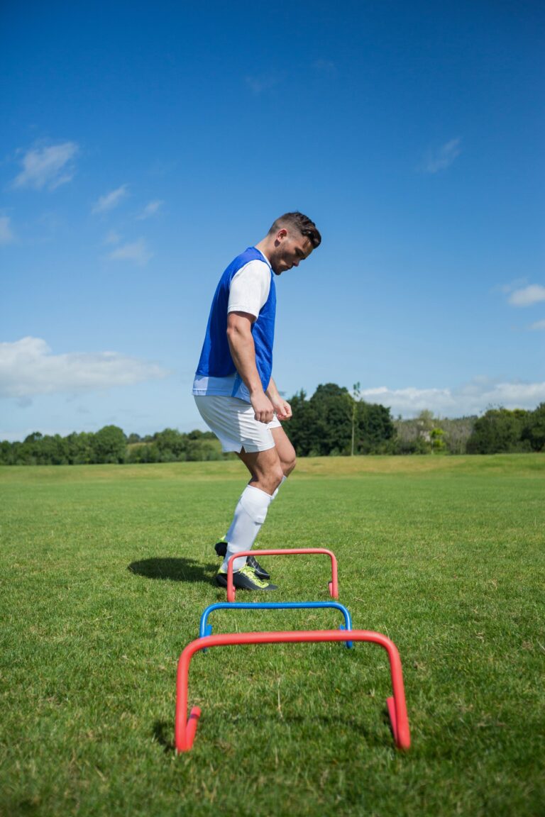 Soccer player practicing on obstacle