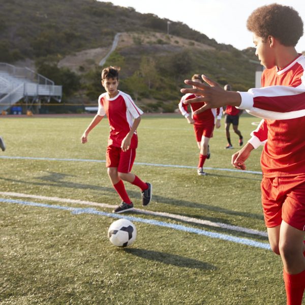 Group Of Male High School Students Playing In Soccer Team