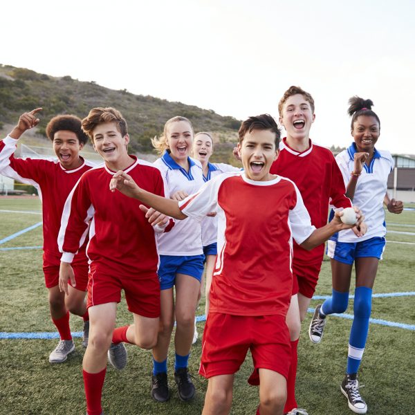 Portrait Of Male And Female High School Soccer Teams Celebrating