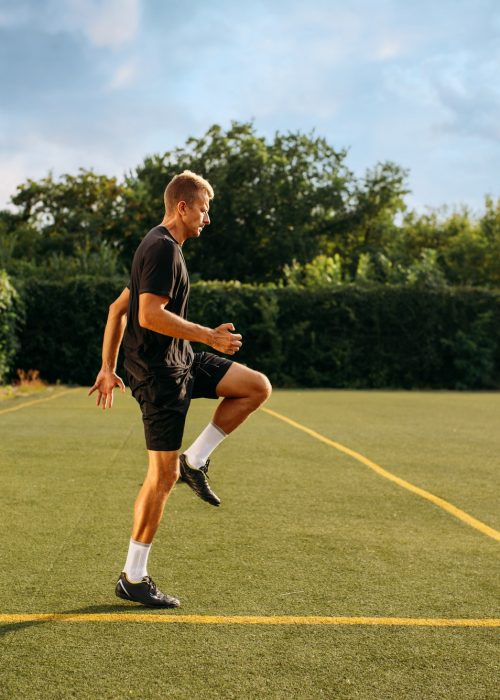 Two male soccer players training on the field